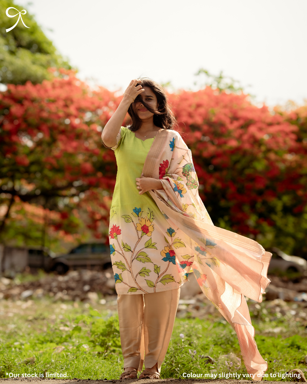 Woman wearing a green Kolam Silk Pichwai printed salwar suit set with matching bottom and floral printed dupatta.
