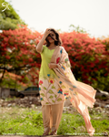 Woman wearing a green Kolam Silk Pichwai printed salwar suit set with matching bottom and floral printed dupatta.