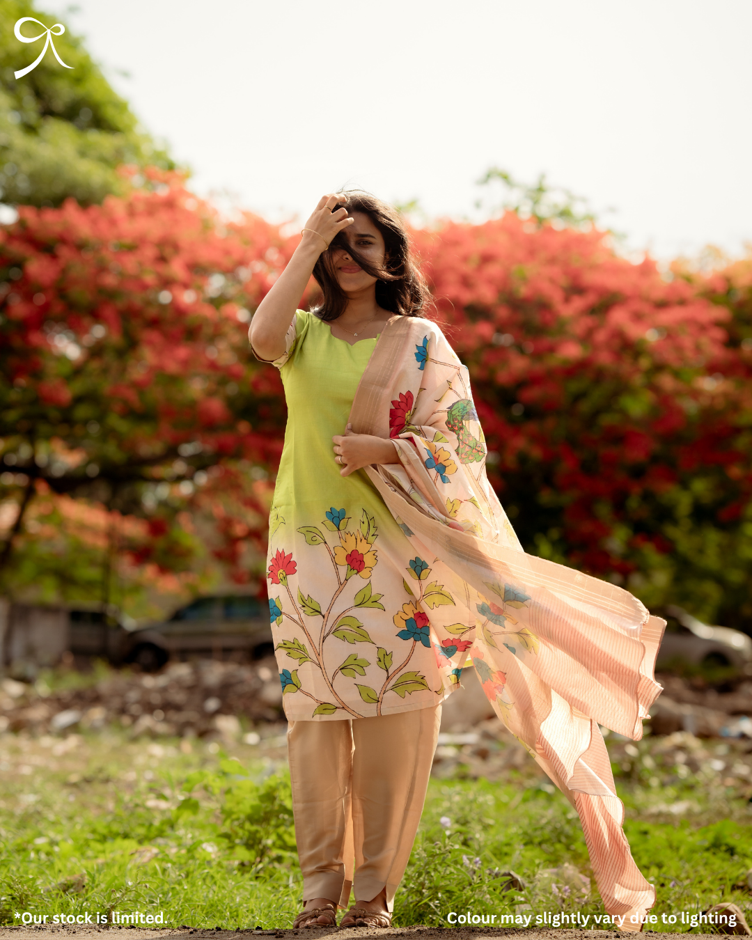 Woman wearing a green Kolam Silk Pichwai printed salwar suit set with matching bottom and floral printed dupatta.