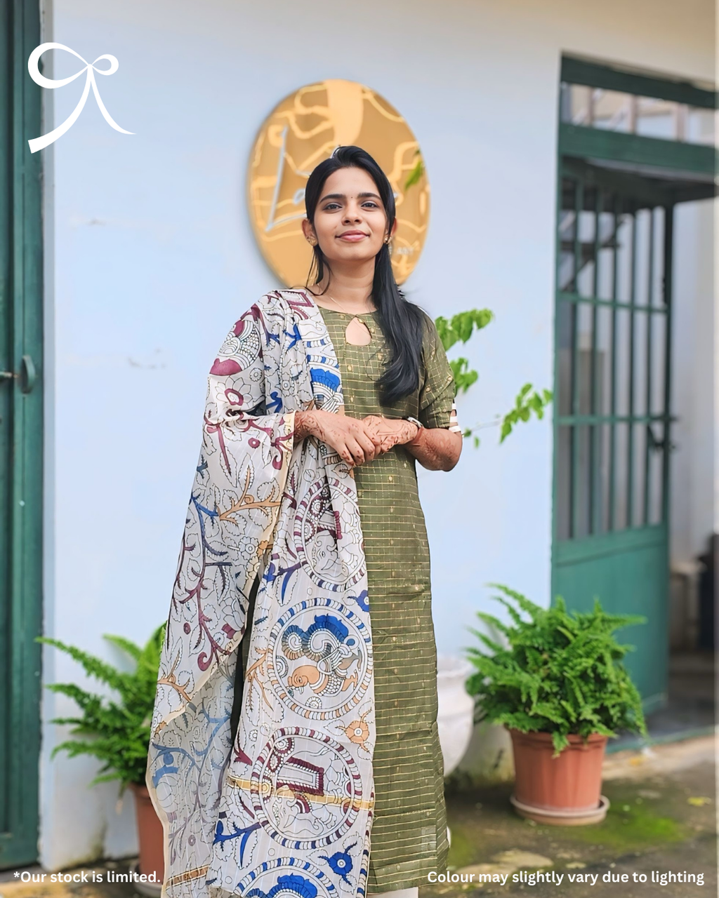 Model wearing Olive Raw Silk Zari Checks Suit Set with Kalamkari dupatta, outdoor setting — Page maintained by Creations by Nash.