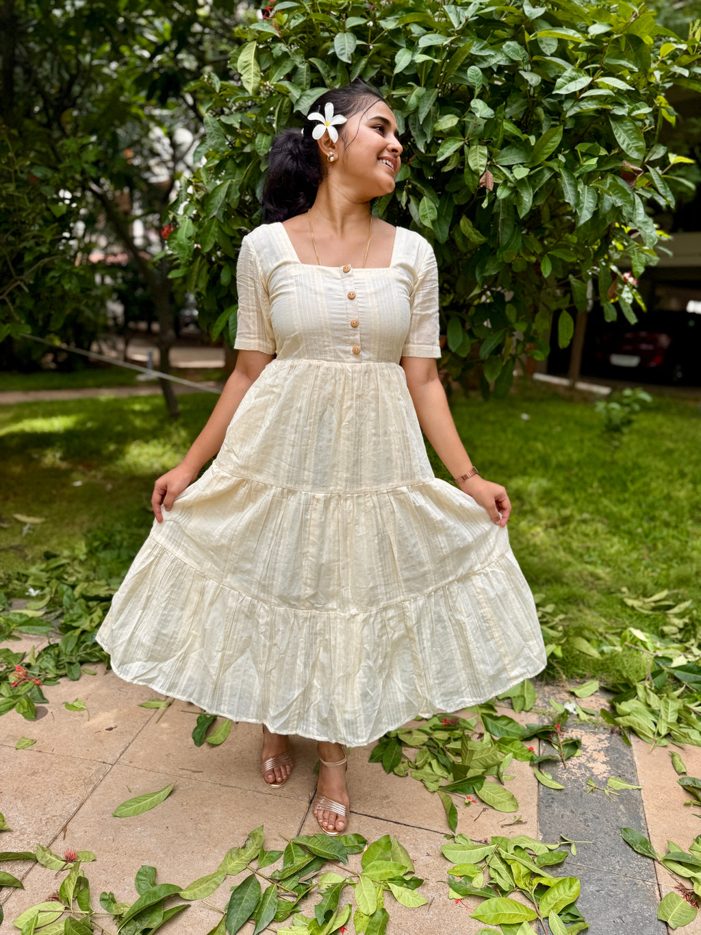 Model wearing Devrobes Vennila Velicham Dress – ivory cotton tiered maxi with soft flow and back tie detailing. Page maintained by Creations by Nash.