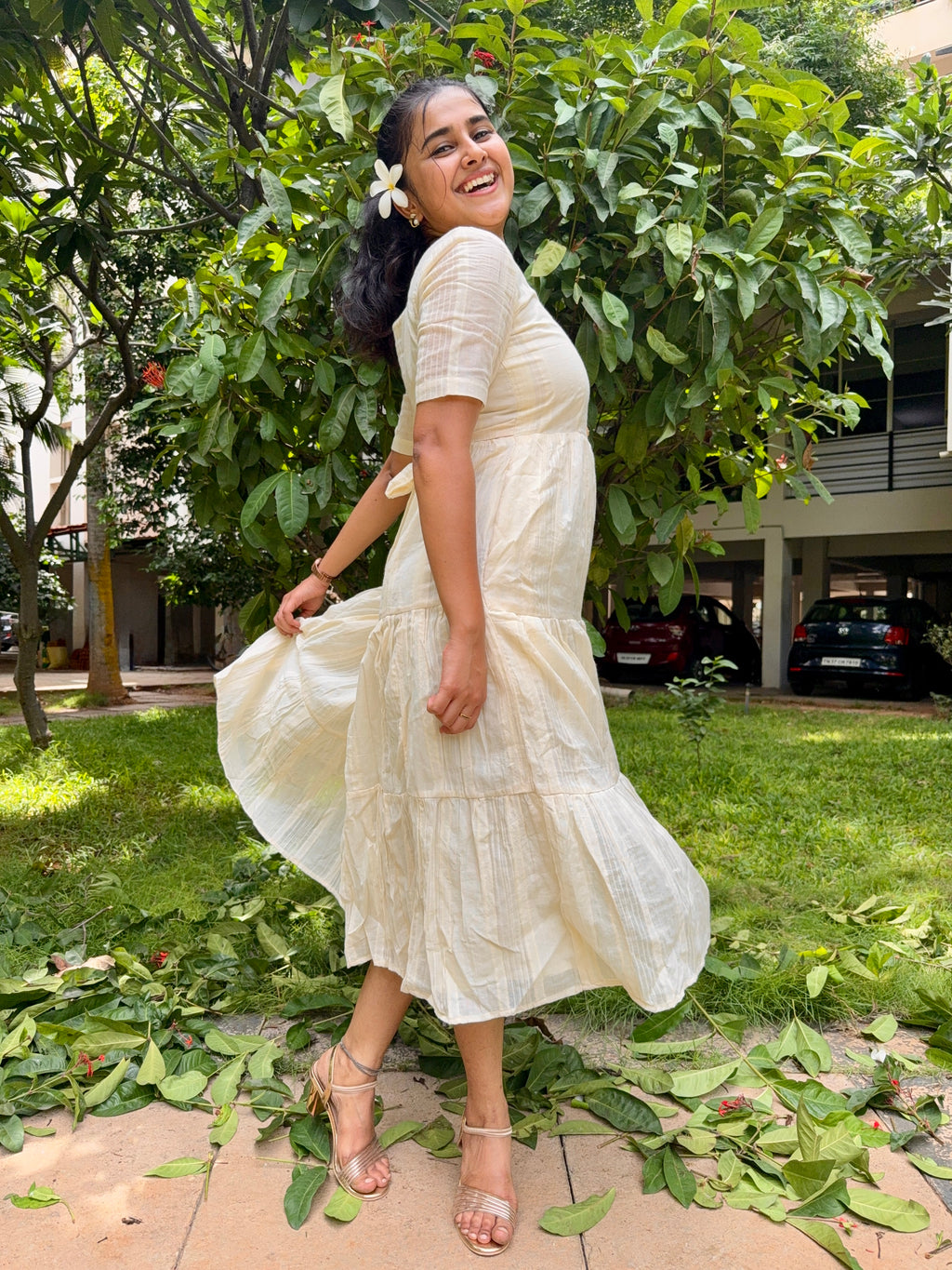 Model wearing Devrobes Vennila Velicham Dress – ivory cotton tiered maxi with soft flow and back tie detailing. Page maintained by Creations by Nash.