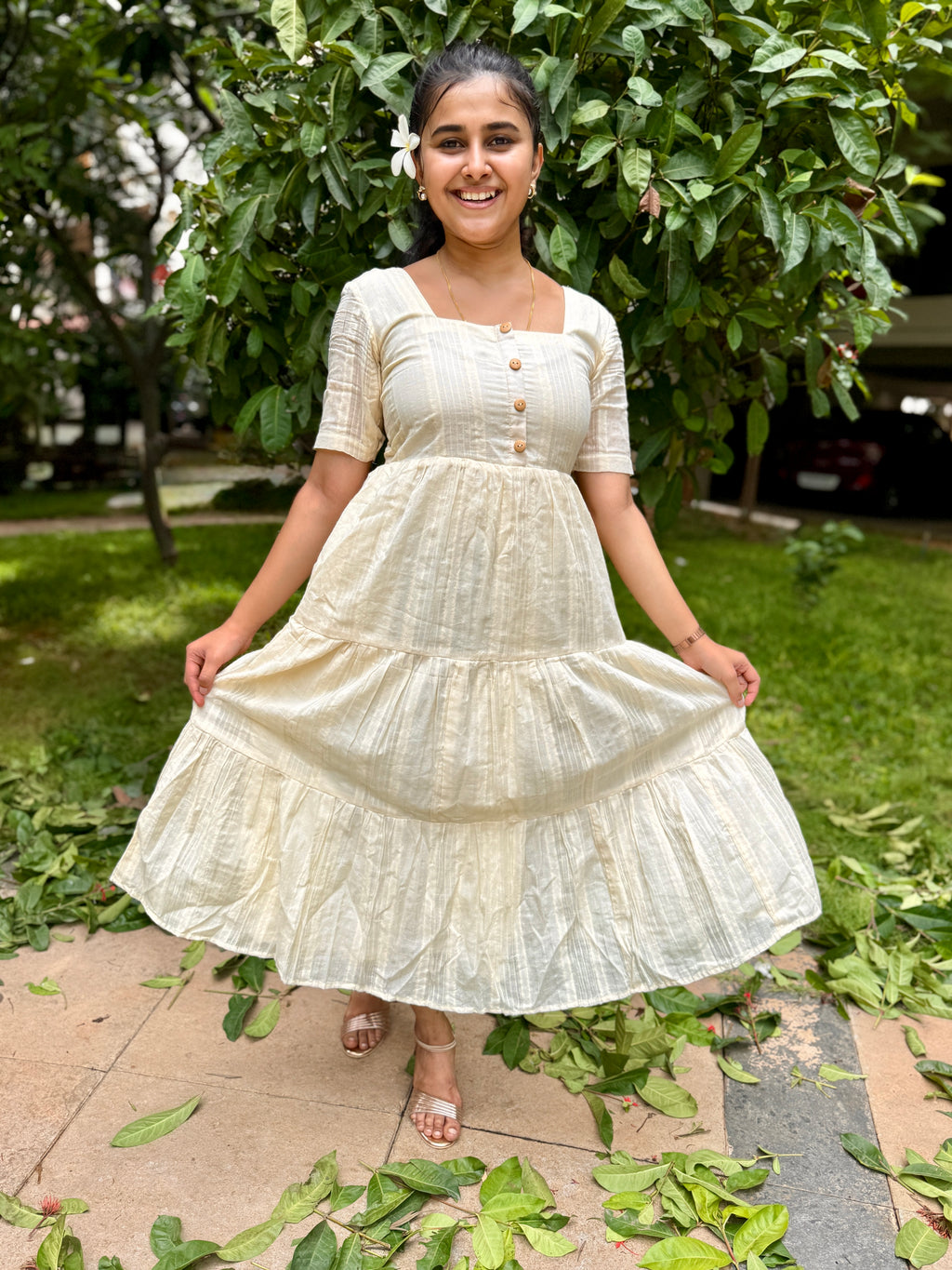 Model wearing Devrobes Vennila Velicham Dress – ivory cotton tiered maxi with soft flow and back tie detailing. Page maintained by Creations by Nash.