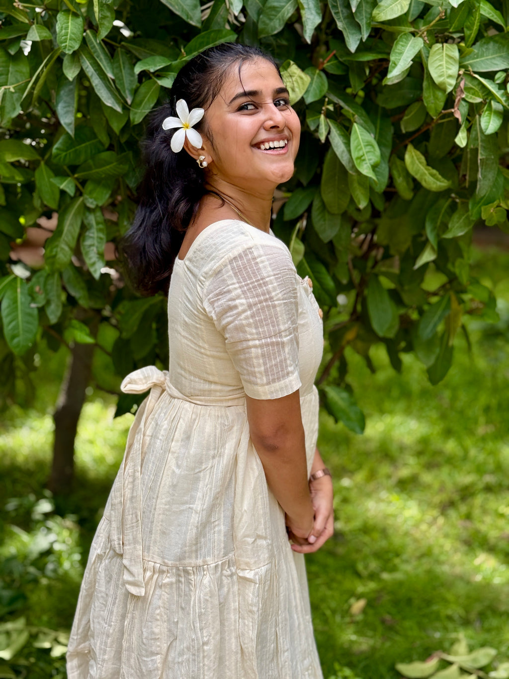 Model wearing Devrobes Vennila Velicham Dress – ivory cotton tiered maxi with soft flow and back tie detailing. Page maintained by Creations by Nash.