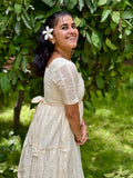 Model wearing Devrobes Vennila Velicham Dress – ivory cotton tiered maxi with soft flow and back tie detailing. Page maintained by Creations by Nash.