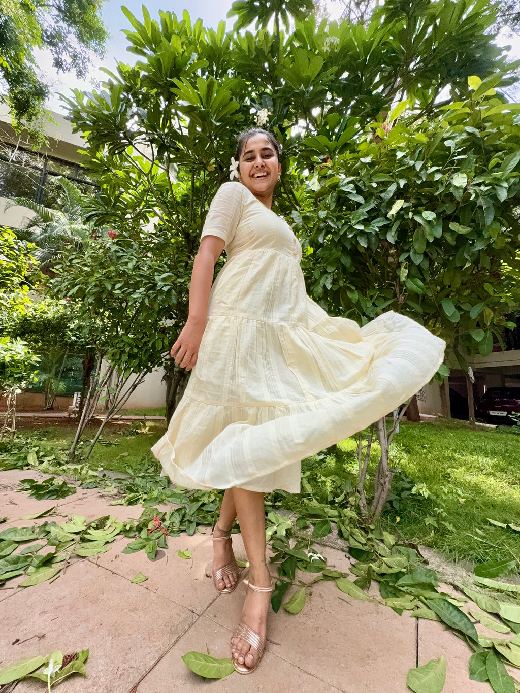 Model wearing Devrobes Vennila Velicham Dress – ivory cotton tiered maxi with soft flow and back tie detailing. Page maintained by Creations by Nash.
