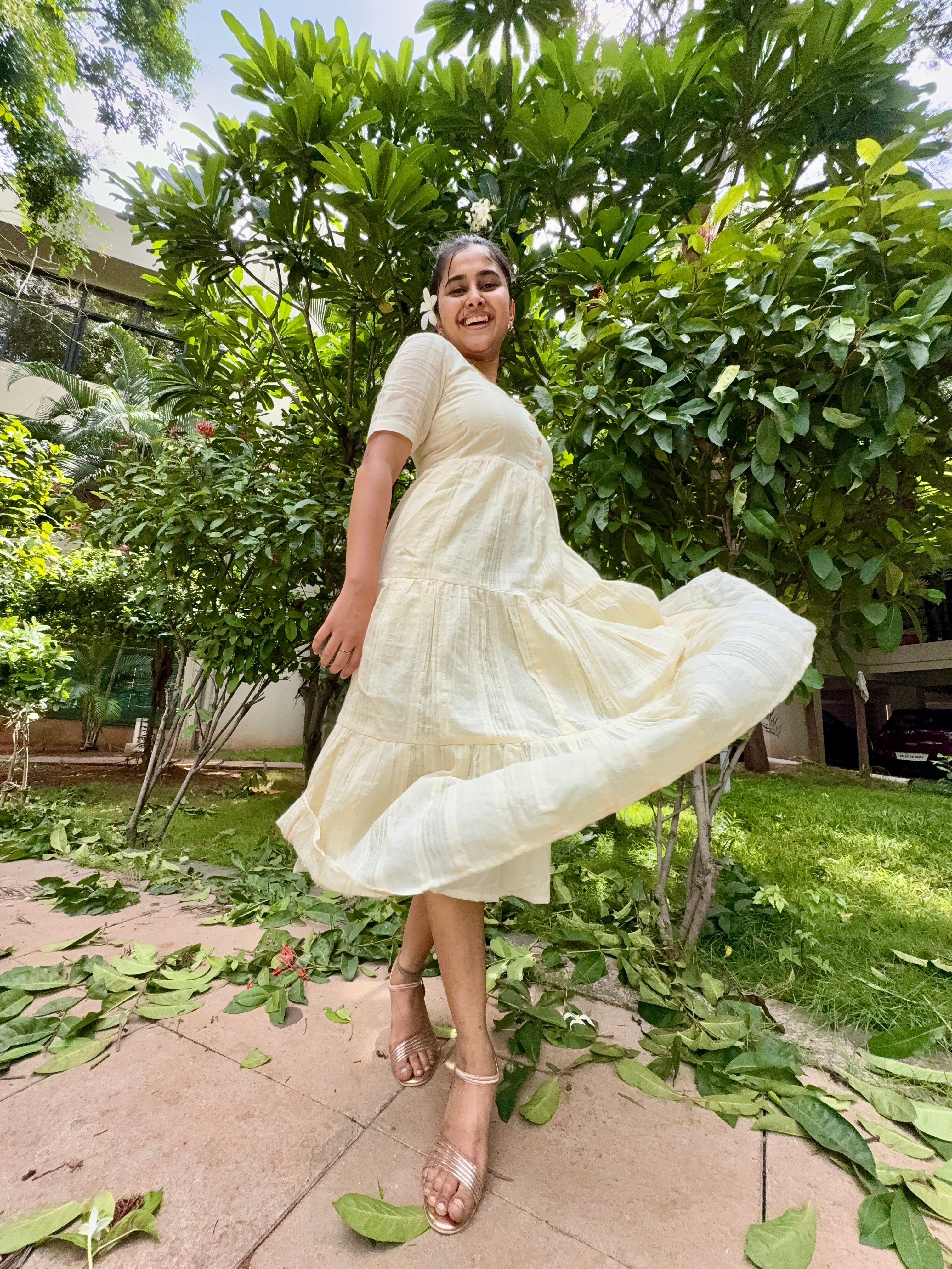 Model wearing Devrobes Vennila Velicham Dress – ivory cotton tiered maxi with soft flow and back tie detailing. Page maintained by Creations by Nash.