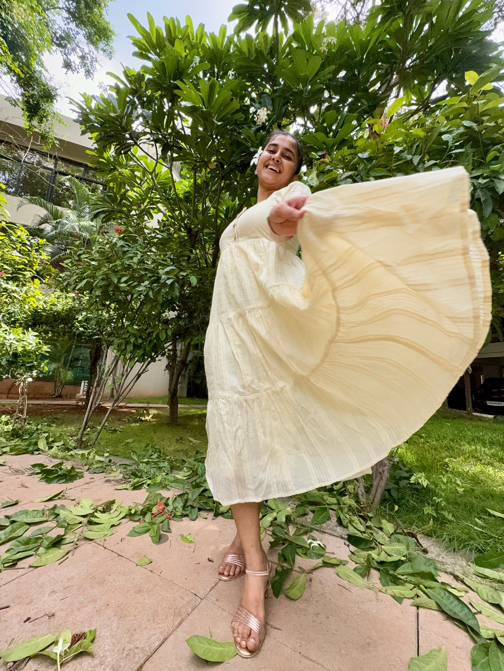 Model wearing Devrobes Vennila Velicham Dress – ivory cotton tiered maxi with soft flow and back tie detailing. Page maintained by Creations by Nash.