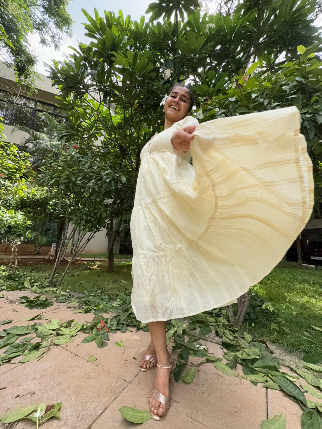 Model wearing Devrobes Vennila Velicham Dress – ivory cotton tiered maxi with soft flow and back tie detailing. Page maintained by Creations by Nash.